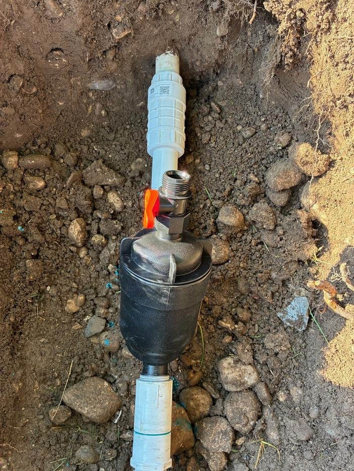 The same run rebuilt in dry ground with a new coupling, shut-off valve and drain.
