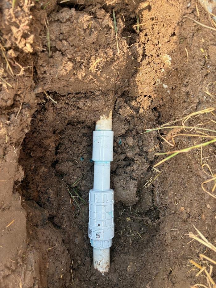 The taped joint cut out and replaced with a new slip repair coupling.